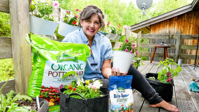 Maria from Growing Joy with Maria with plants and organic potting soil and organic fertilizer from Espoma Organic Potting Mix and Bio-tone on her balcony