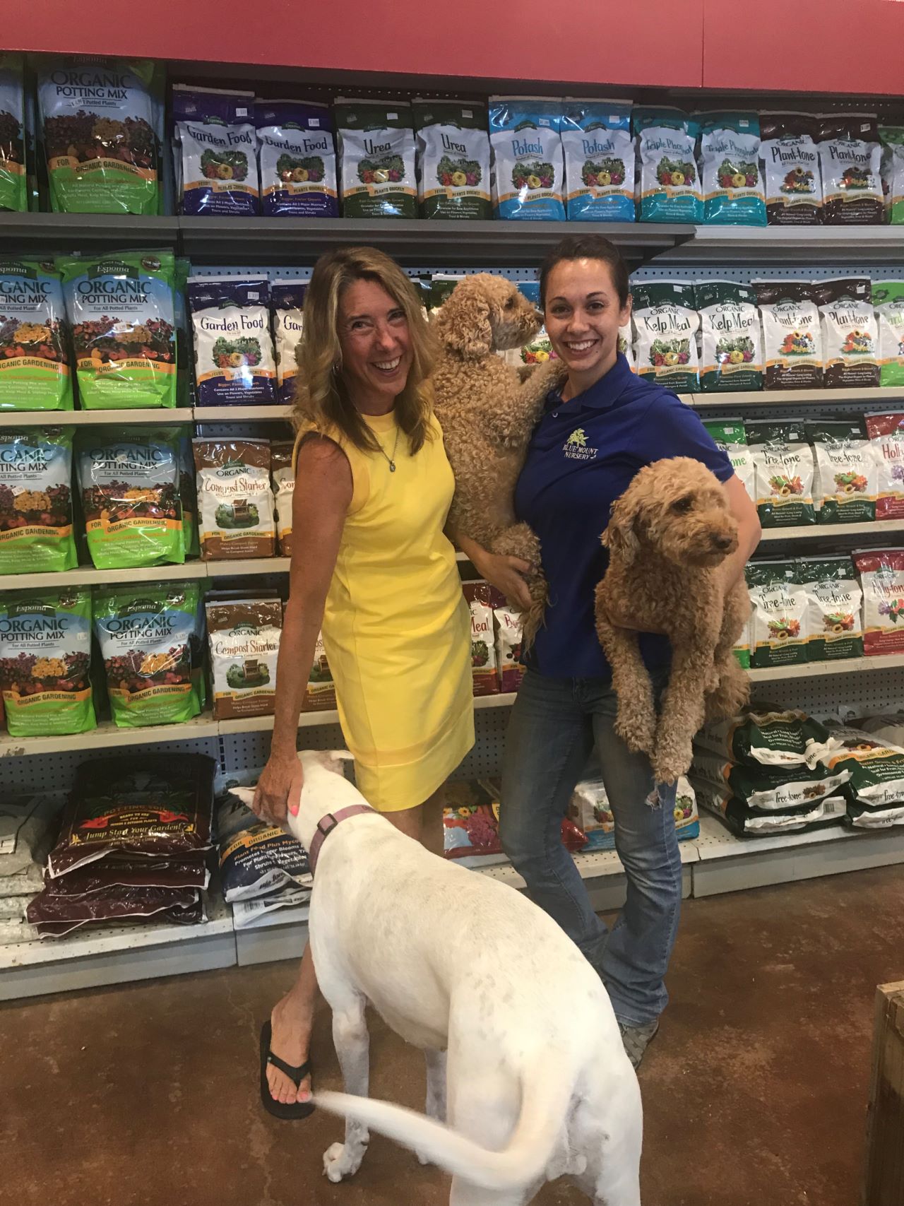 Espoma Organic in aisle, with dogs and two woman